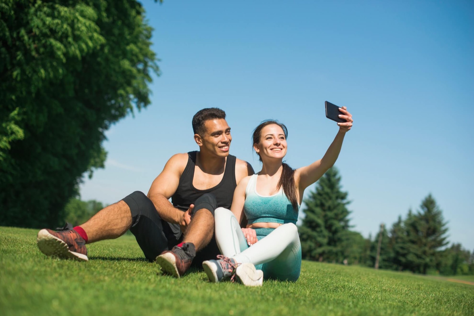 A couple sitting outdoors together after a workout